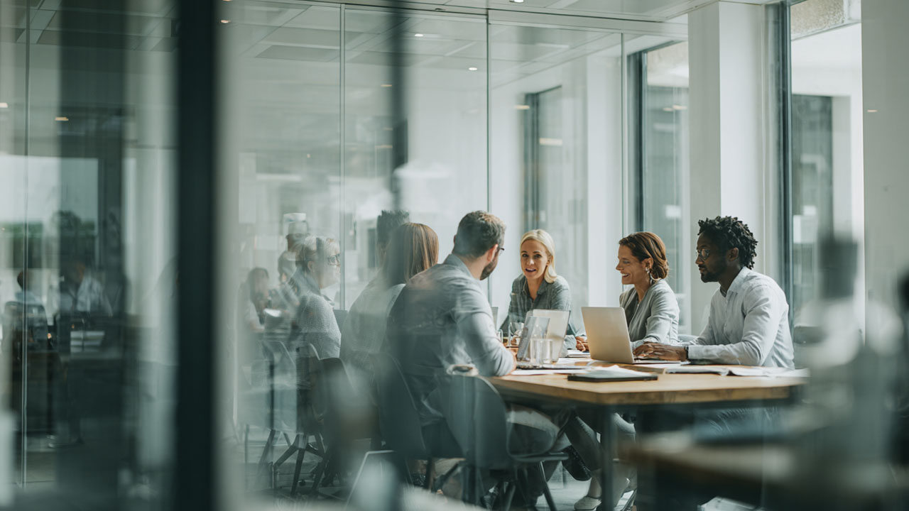 A diverse team of business professionals collaborating in a modern office during a training session