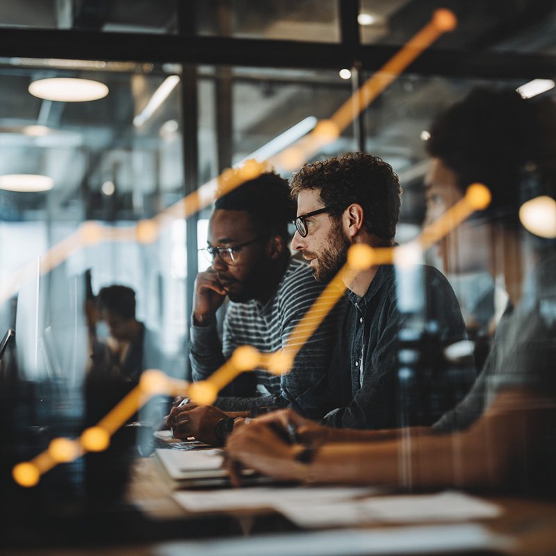 Corporate team reviewing data and performance metrics, symbolizing the measurable business value of reskilling through productivity gains, retention, and ROI.