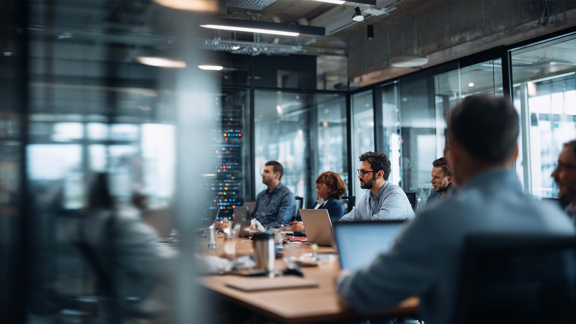 IT professionals in a modern training room collaborating on mainframe systems